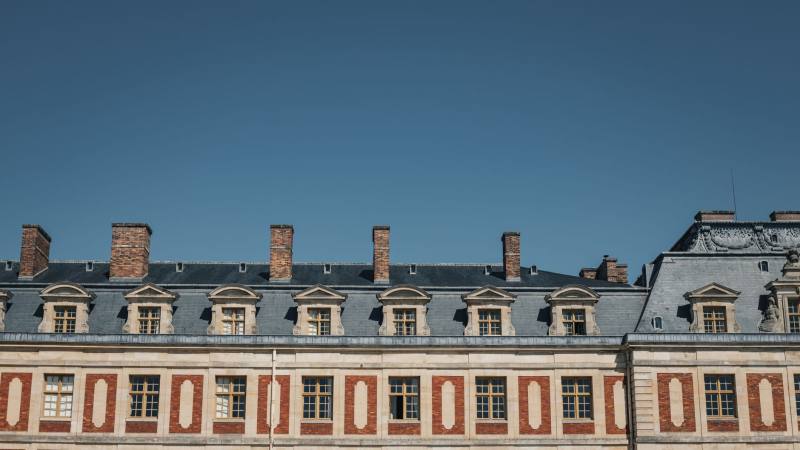 Détecteur de fumée blanc installé au plafond d’une pièce claire